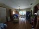 View of the living room with hardwood floors, lots of furniture, and a chandelier at 4343 Arrow Ave, Sarasota, FL 34232