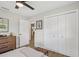 A stylish bedroom featuring light gray walls, modern furniture, and a spacious closet at 4344 Bent Tree Blvd, Sarasota, FL 34241