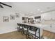 Bright kitchen boasts a large island with seating and modern white cabinetry at 4344 Bent Tree Blvd, Sarasota, FL 34241