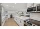 Kitchen with a large center island, wine cooler, stainless steel appliances, and modern finishes at 4344 Bent Tree Blvd, Sarasota, FL 34241