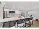 Modern kitchen with long island featuring seating, white cabinets, and backyard views at 4344 Bent Tree Blvd, Sarasota, FL 34241