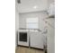 Bright laundry room with newer washer and dryer, utility sink, and cabinet storage at 4344 Bent Tree Blvd, Sarasota, FL 34241