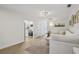 Open-concept living space with hardwood floors and a cozy sectional sofa at 4344 Bent Tree Blvd, Sarasota, FL 34241