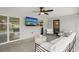 Screened outdoor living space with comfortable seating, ceiling fan, and exterior views at 4344 Bent Tree Blvd, Sarasota, FL 34241