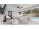 Screened outdoor living space with comfortable seating, ceiling fan, and view of the pool at 4344 Bent Tree Blvd, Sarasota, FL 34241