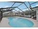 Full in-ground swimming pool surrounded by a screened lanai with outdoor sitting and dining areas at 4344 Bent Tree Blvd, Sarasota, FL 34241