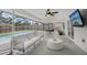 Screened outdoor living space with comfortable seating, ceiling fan, and view of the pool at 4344 Bent Tree Blvd, Sarasota, FL 34241