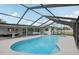 Inviting in-ground pool under a screened lanai with multiple gathering spaces for entertaining at 4344 Bent Tree Blvd, Sarasota, FL 34241
