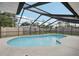 Relaxing in-ground pool under a screened lanai with bright blue water and a concrete deck at 4344 Bent Tree Blvd, Sarasota, FL 34241