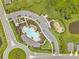 Aerial view of community featuring clubhouse, pool, playground, pond, parking, and landscaping at 4405 Weathered Moss Gln, Palmetto, FL 34221