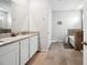 Bathroom featuring double sinks with granite counters, tile floors, tub, and shower at 4405 Weathered Moss Gln, Palmetto, FL 34221