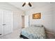 Bright and airy bedroom with neutral walls, carpet, ceiling fan and closet at 4405 Weathered Moss Gln, Palmetto, FL 34221