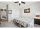 Cozy bedroom featuring plush carpet, a ceiling fan, closet and a comfortable bed at 4405 Weathered Moss Gln, Palmetto, FL 34221