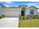 Charming single-story home featuring a two-car garage and a well-maintained front yard at 4405 Weathered Moss Gln, Palmetto, FL 34221