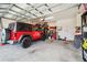 Spacious garage featuring an open door, car, storage racks, and concrete floor at 4405 Weathered Moss Gln, Palmetto, FL 34221
