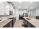 Kitchen features granite countertops, stainless steel appliances, white cabinets, and gold hardware at 4405 Weathered Moss Gln, Palmetto, FL 34221