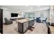 Open-concept kitchen features a large island with granite counters, stainless steel appliances, and a dining area at 4405 Weathered Moss Gln, Palmetto, FL 34221