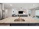 Kitchen island featuring granite countertops, stainless steel sink, and gold faucet at 4405 Weathered Moss Gln, Palmetto, FL 34221