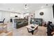 Open-concept living area featuring modern furniture, kitchen access, and natural light at 4405 Weathered Moss Gln, Palmetto, FL 34221