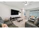 Spacious living room featuring modern furniture, a large TV, and plenty of natural light at 4405 Weathered Moss Gln, Palmetto, FL 34221