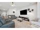 Cozy living room showcasing comfortable seating, a large TV, and stylish decor at 4405 Weathered Moss Gln, Palmetto, FL 34221