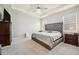 Bright main bedroom featuring a large bed, ceiling fan, and neutral tones at 4405 Weathered Moss Gln, Palmetto, FL 34221