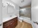 Bathroom featuring a modern vanity, mirror with lights, updated shower with glass doors, and sleek fixtures at 4455 Emerald Ridge Dr, Sarasota, FL 34233