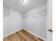 Walk-in closet offers organized storage solutions with sleek shelves and ample space for clothing and accessories at 4455 Emerald Ridge Dr, Sarasota, FL 34233