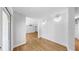 Hallway featuring light wood floors and white textured walls with architectural lighting at 4455 Emerald Ridge Dr, Sarasota, FL 34233
