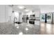 Modern kitchen with stainless steel appliances, granite countertops, and open layout at 4455 Emerald Ridge Dr, Sarasota, FL 34233