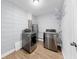 This laundry room features stainless steel washer and dryer, water heater and durable flooring at 4455 Emerald Ridge Dr, Sarasota, FL 34233
