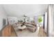 Large open-plan living room with neutral tones, wood flooring, and abundant natural light at 4455 Emerald Ridge Dr, Sarasota, FL 34233