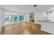 Open concept kitchen and living space with access to the outdoors and sleek countertops at 4455 Emerald Ridge Dr, Sarasota, FL 34233