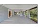 Expansive covered patio with outdoor entertaining space and views of lush greenery at 4455 Emerald Ridge Dr, Sarasota, FL 34233