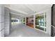 Enclosed patio with gray tiled floors and a glimpse into the home's interior at 4455 Emerald Ridge Dr, Sarasota, FL 34233