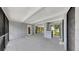 Open patio with concrete block and grey brick flooring leading to glass doors and screened doorways at 4455 Emerald Ridge Dr, Sarasota, FL 34233