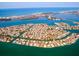 Stunning aerial view showcases a waterfront community with numerous homes, canals, and access to the beautiful blue sea at 483 Partridge Cir, Sarasota, FL 34236