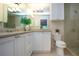 Bright bathroom with white cabinetry, marble countertop, and a glass-enclosed shower at 483 Partridge Cir, Sarasota, FL 34236