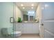 Bathroom features white cabinets, granite counters, tile floors, and a glass shower at 483 Partridge Cir, Sarasota, FL 34236