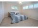 Comfortable bedroom with two windows, neutral tones, and a ceiling fan at 483 Partridge Cir, Sarasota, FL 34236