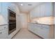 Bright kitchen with stainless appliances, white cabinetry, and tiled floors at 483 Partridge Cir, Sarasota, FL 34236