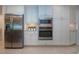 Bright kitchen featuring stainless steel appliances, white cabinetry and tile backsplash at 483 Partridge Cir, Sarasota, FL 34236
