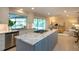 An open-concept kitchen with stainless steel appliances, center island, and views of the pool at 483 Partridge Cir, Sarasota, FL 34236