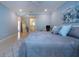 Bright main bedroom featuring cool blue walls, tile floor, and modern furnishings at 483 Partridge Cir, Sarasota, FL 34236