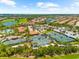 Scenic aerial view featuring tennis courts, a clubhouse, and lush landscaping in a residential community at 5121 Serata Dr, Lakewood Ranch, FL 34211
