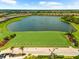 Breathtaking aerial view of a community with a pond, golf course, and lush landscaping under a blue sky with clouds at 5121 Serata Dr, Lakewood Ranch, FL 34211