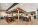 Expansive bar area with wood floors, high ceilings, natural light, and table seating that creates a welcoming atmosphere at 5121 Serata Dr, Lakewood Ranch, FL 34211