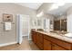 Spacious bathroom features double sink vanity with granite countertops, walk-in shower and access to the walk-in closet at 5121 Serata Dr, Lakewood Ranch, FL 34211