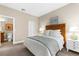 Comfortable bedroom with ensuite bathroom, bedside tables, lamps and a neutral color palette at 5121 Serata Dr, Lakewood Ranch, FL 34211