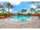 Community pool with lounge chairs, palm trees, and resort-style amenities at 5121 Serata Dr, Lakewood Ranch, FL 34211